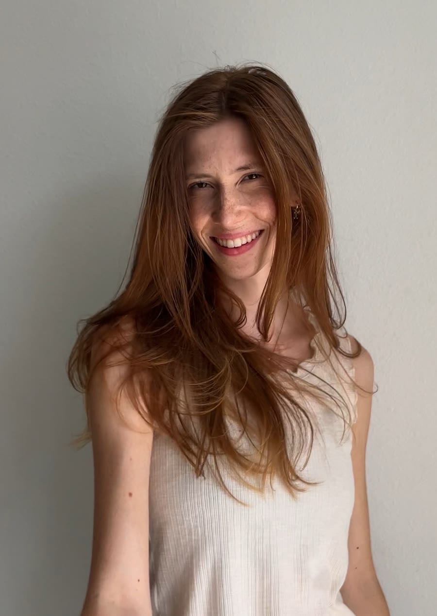 Gabriela smiling in a white top